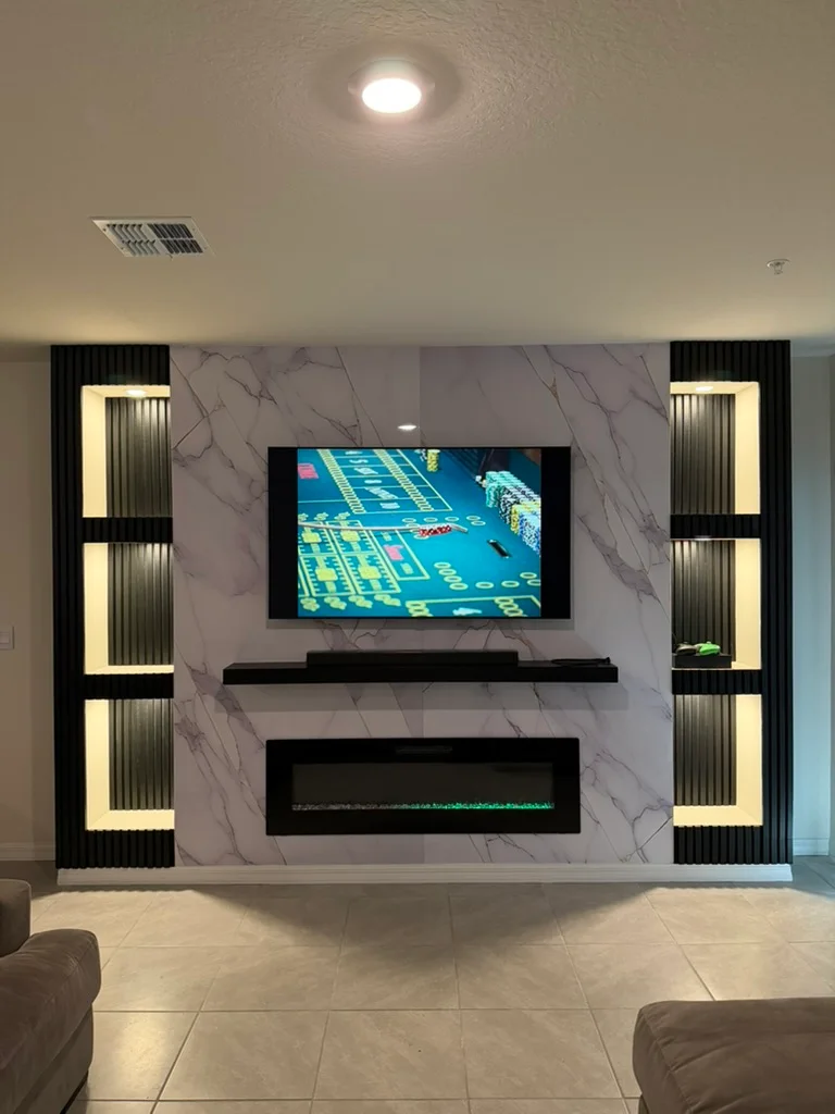 Finished tiled media wall with an electric fireplace and illuminated display niches