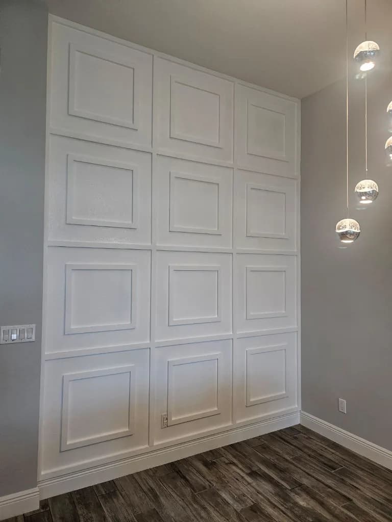 Finished white accent wall with inset panel molding